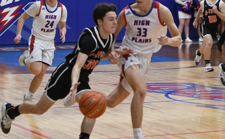 Osceola's Brayden Santos pushes the ball past Carter Urkoski on his way to the basket. PCN photo by Rick Holtz