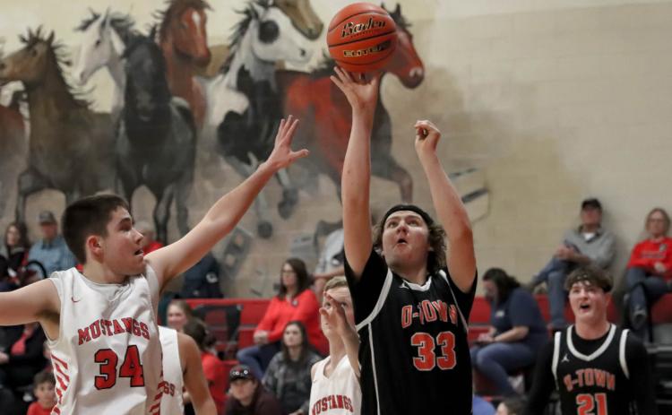 Koleton Udey goes up for the basket with Kale Gustafson in the background. PCN photo by Blaine Winslow.