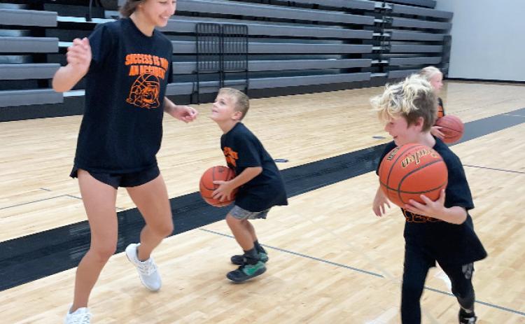 Rori Wiseman, left, plays  defense on Braxton Borer last week at Osceola Schools Youth Basketball Camp before the camp session began. Zane Bise works on his mid-range jump shot before the camp session began. Camps continued this week as the Lil'Dawgs Football Camp kicked off Monday and Tuesday and continues today and Friday for first through third grade and fourth through eighth grade. Polk County News photo by Rick Holtz