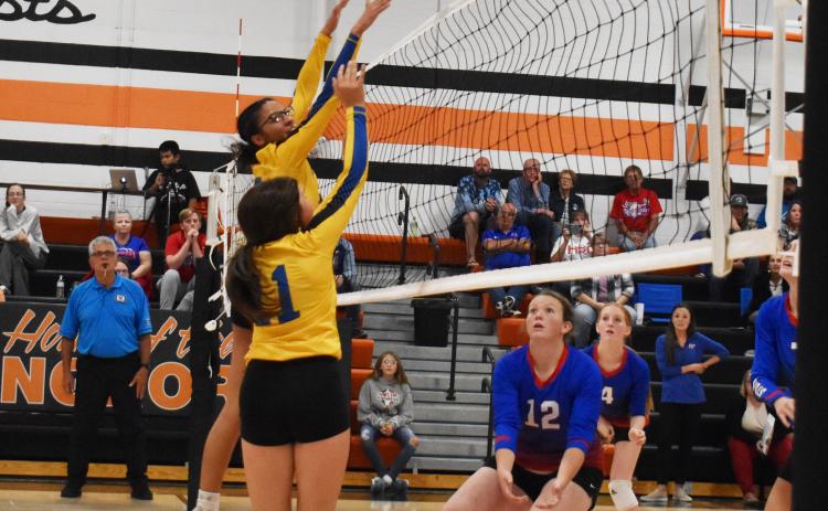 SRC’s Zoey Walker and Brooklynn Baker go for a tip as High Plain’s Allie Howell prepares for the ball to come back over the net. PCN photo by Beth Sparrow