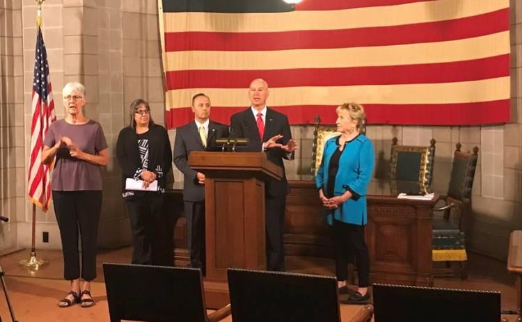 From Left to Right: ASL Interpreter Frances Beaurivage, Property Tax Administrator Ruth Sorensen,  Tax Commissioner Tony Fulton, Gov. Ricketts (podium), and State Senator Lou Ann Linehan. Photo provided
