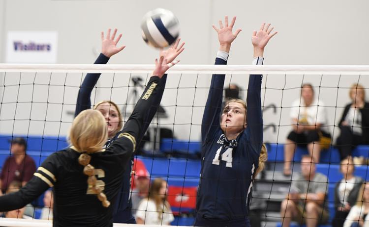 Bren Lemburg and Shyanne Anderson cause problems for the Aquinas hitter on Saturday. PCN photo by Rick Holtz