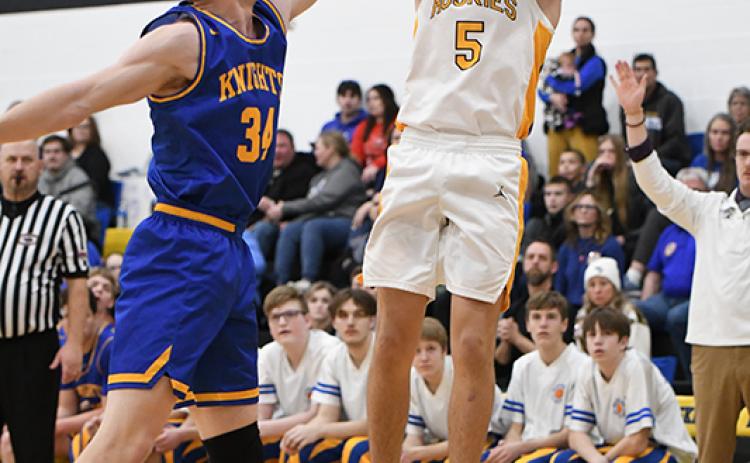 Blake Schmidt gets a shot off in the first quarter despite tight defense from Nebraska Christian. PCN photo by Rick Holtz