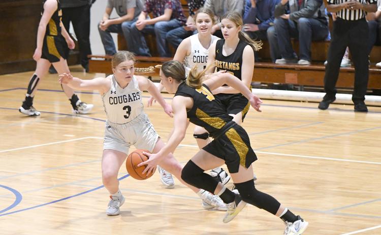 Ema Dickey had her hands full on defense when she was matched-up with McKenna Yates. Dickey scored a team-high 9 points and Yates finished with a game-high 17 points for McCool Junction. PCN photo by Rick Holtz