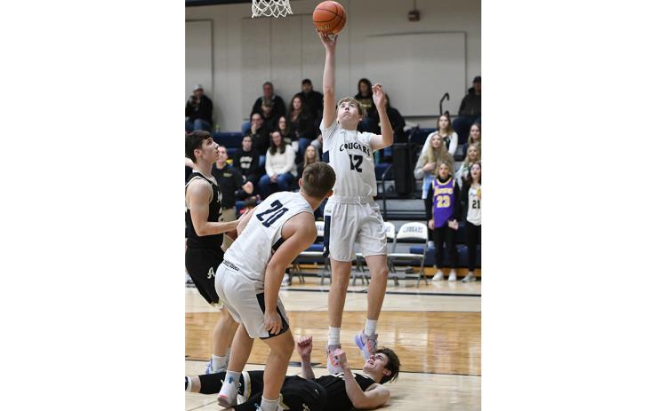 Ashton Seim finishes at the basket off an assist from Alex Noyd for two of his game-high 25 points Thursday against Aquinas Catholic.PCN photos by Rick Holtz