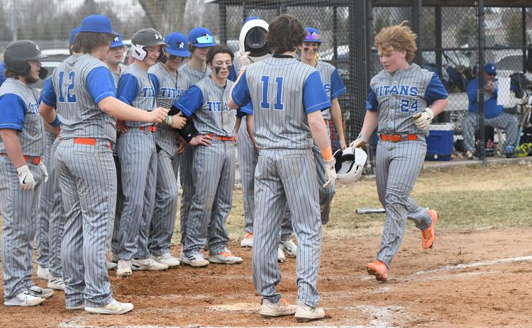 Twin River's bench gathers around home plate as Paydon Rinkol rounds the bases following his second inning two-run home run. PCN photo by Rick Holtz