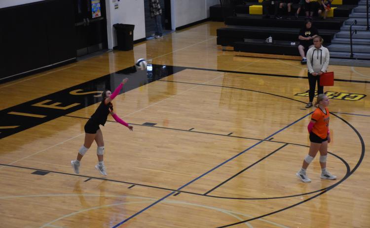 Ella Lemburg serves for Osceola.