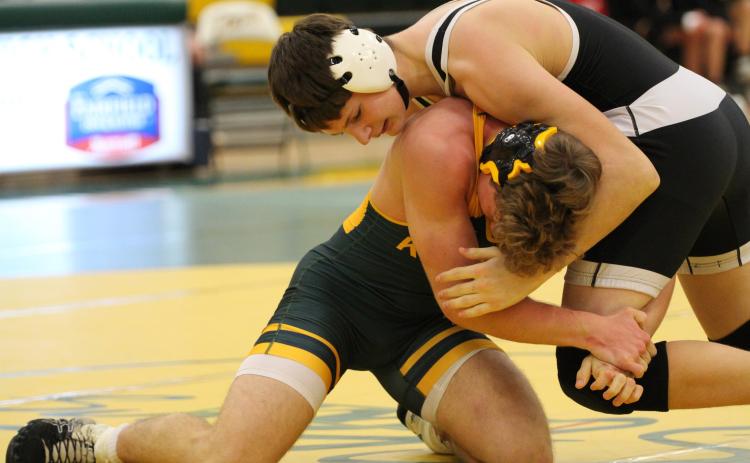 Paxton Burke (CCO) wrestles Austin Smith of Kearney Catholic. PCN photo by Travis Lane.