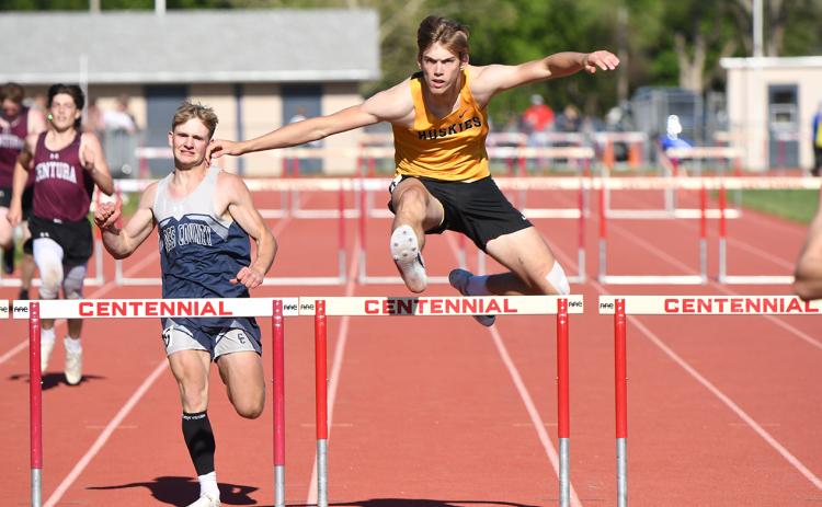 Cole Redden (CC, left) and Isaac Whitmore (SRC, right) jump the 300m intermediate hurdles at districts. They both qualified for state. PCN photo by Rick Holtz