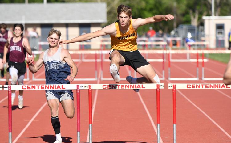 Cole Redden (CC, left) and Isaac Whitmore (SRC, right) jump the 300m intermediate hurdles at districts. They both qualified for state. PCN photo by Rick Holtz