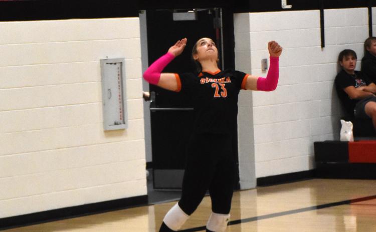 Bella Recker (OSC) serves.
