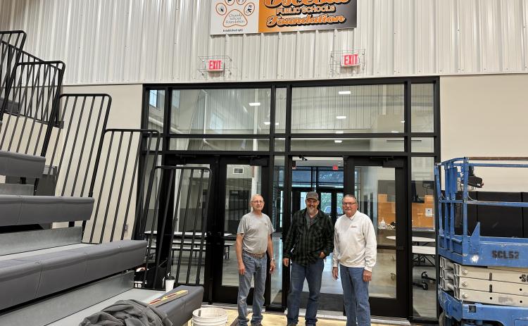 The new Osceola Foundation sign hangs high in the Osceola gym. The three volunteers pictured here (L-R) Jerry Miller, Jesse Pliefke and Ron Boruch installed the sign. Photo was provided.