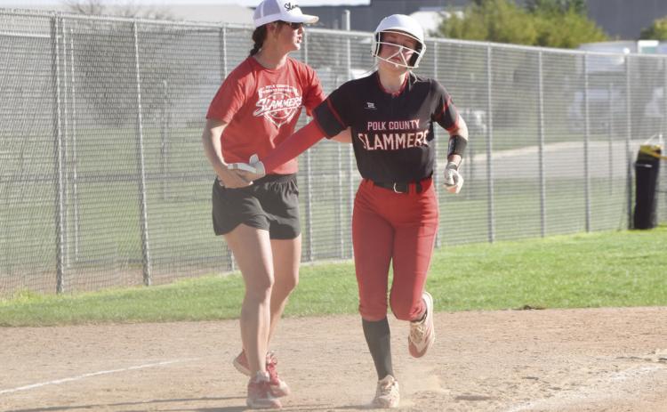 PCA head coach Angie Schroetlin congratulates junior Faith Samek after she hit a seventh inning home run at the B-1 in Hastings. PCN photo by Beth Sparrow.