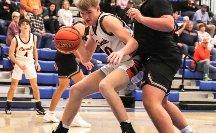 ABOVE: Braxton Mestl dribbles around a BDS opponent near the basket. PCN photo by Blaine Winslow.