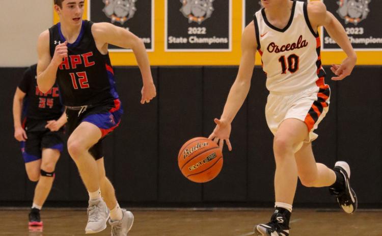 Hudson Prososki (OSC) takes the ball on a fast break against Haden Helgoth (HPC). PCN photo by Blaine Winslow.