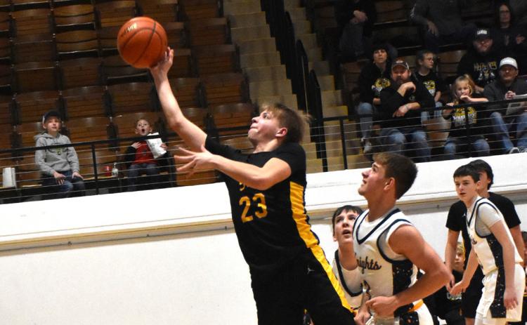 Jaxson Thompson takes the ball up to the basket for two with Nebraska Lutheran trying to stop him. PCN photo by Beth Sparrow.