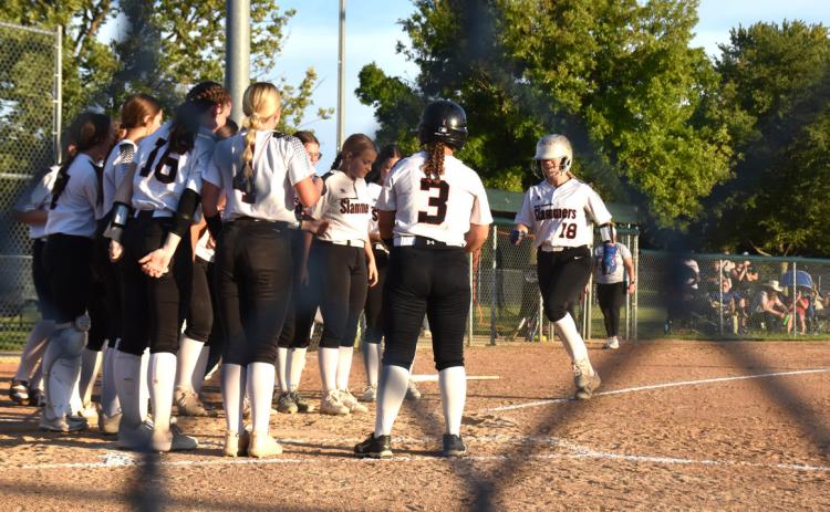 The Slammers welcome Mady Berggren home after her home run against Central City. The Slammers lost 12-11. PCN photo by Beth Sparrow.