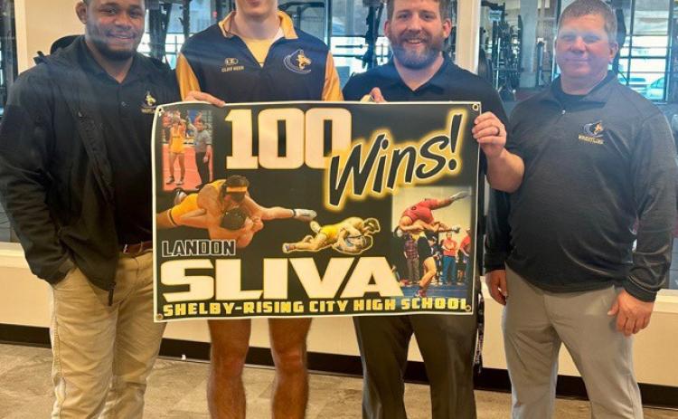 Landon Sliva (senior at Shelby-Rising City) recently got his 100th win in wrestling. He is pictured (second from left) with his coaches. Photo provided.