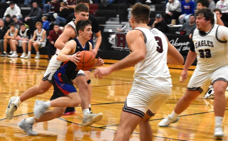 Haden Helgoth tries to take the ball to the basket past several Eagle defenders. PCN photo by Cienna Friesen.