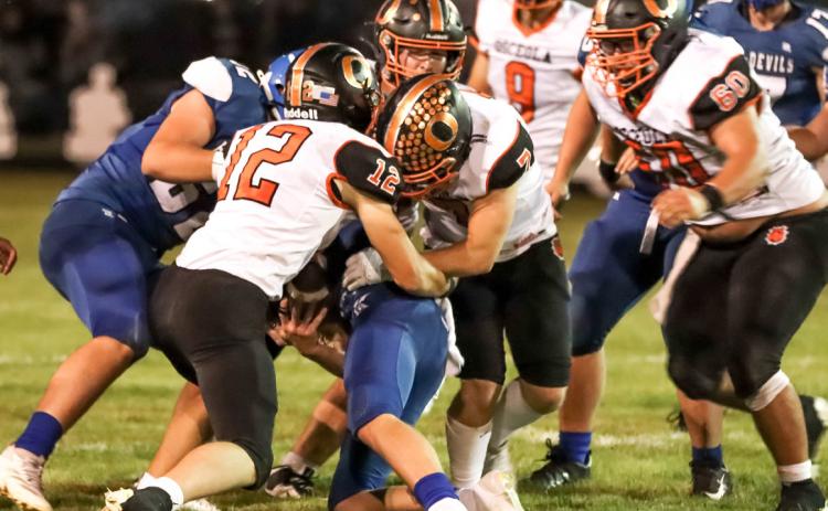 Liam White and Aden Feezell are making the stop against the Blue Devils on Friday. PCN photo by Blaine Winslow.