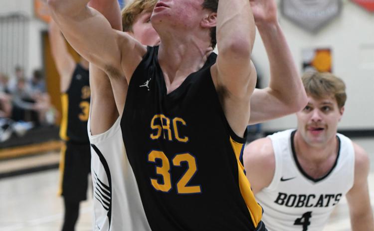 Dylan Micek tries to keep the rebound away from EMF. PCN photo by Calvin Holtz.