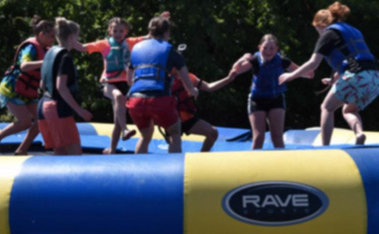 Kids at Royal Family Kids Camp are having fun on a large intertube. Photo provided.