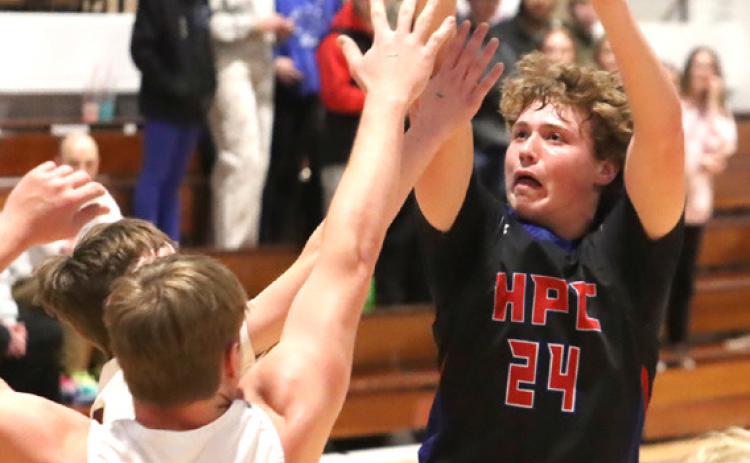 Storm senior Chase Owens (24) takes the shot over East Butler’s Drew Wachal (50) during last Thursday night CRC semifinal at the York CityAuditorium. PCN photo by Ken Kush.