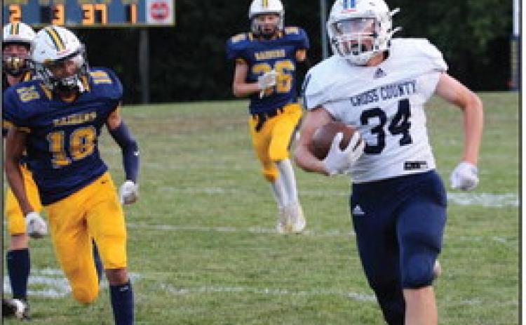 Above:Ashton Seim (#34) runs the ball in for a touchdown pursued by some defenders. Ashton would finish with two touchdowns and 98 rushing yards. Below: Lucas Jacobson tries to evade a tackle. PCN photos by Travis Lane.