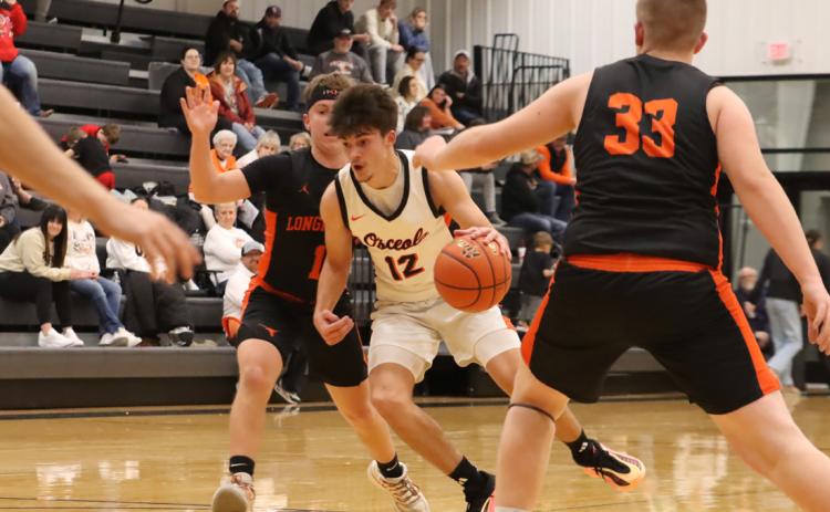 Osceola’s Jackson Winslow (12) drives to the basket in the Bulldogs game with Dorchester. PCN photo by Ken Kush.