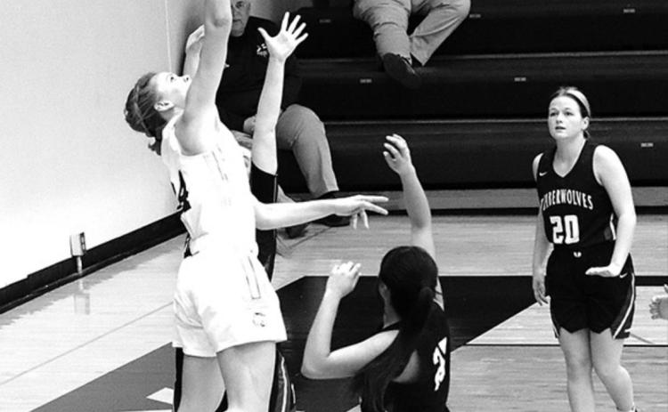 Cross County Senior Chloe Sandell goes up for the rebound in the game against Exeter-Milligan last week. Photo by Angie Hild.