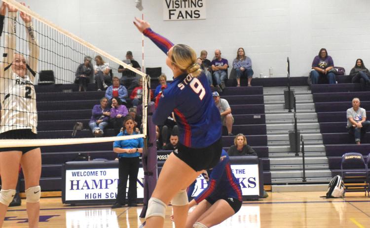 Going into Saturday’s tournament in Hampton, HallieJo Urkoski had registered 16 kills in the team’s first four games of the week. Here she is on the attack against the Lawrence-Nelson Raiders defense. PCN photo by Beth Sparrow