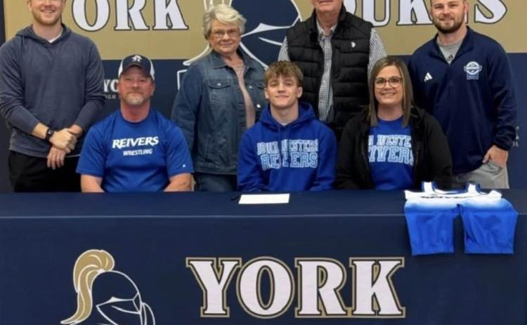 York High School’s Devin Nuttelman will be a Reiver at Iowa Western starting next fall. Devin from Stromsburg signed with Iowa Western last week for wrestling. Front (left to right) Jason Nuttelman (father), Devin Nuttelman, Bridget Nuttelman (mom). Back row- York head coach Ryan Johnson, grandmother Gloria Nuttelman, Grandpa Doug Nuttelman and Reivers head coach Brayden Curry. Photo provided.