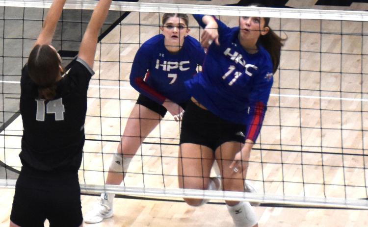Rylee Ackerson hits a kill as EMF tries to block. PCN photo by Beth Sparrow.