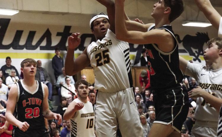 Kelby Neujahr tries to get past a Mustang defender to the basket. PCN photo by Blaine Winslow.
