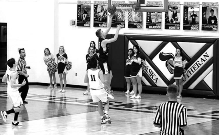 Cougar Shayden Lundstrom takes the ball in for a lay-up. Photo by Angie Hild.