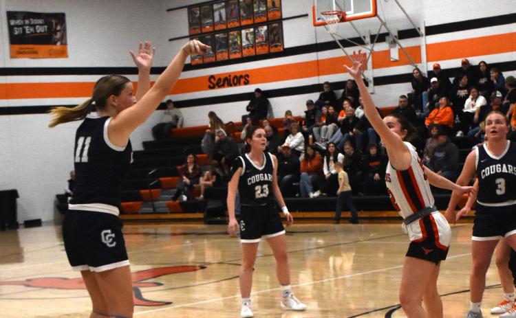 Above: Ella Clark shoots a trey at the Dorchester game. PCN photo by Beth Sparrow.
