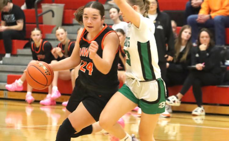 Osceola junior Bella Recker (24) drives against the Bergan Catholic defender in Monday’s game at Mead. Recker led the Bulldogs in scoring with 15. PCN photo by Ken Kush.