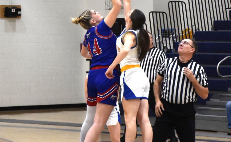 Emma Brown jumps in the tipoff of the girls’ game against Nebraska Lutheran. PCN photo by Beth Sparrow.