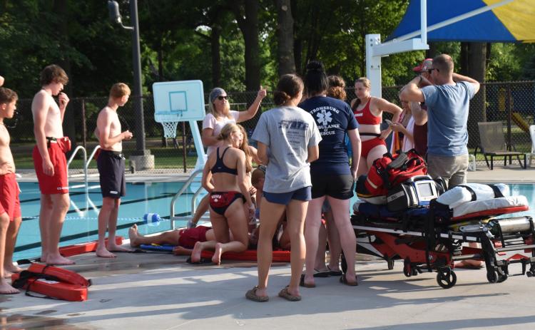 Nancy Hengelfelt (RN, EMT trainer) talks to lifeguards as EMTs stand by in a mock accident at the Stromsburg pool. PCN photo by Beth Sparrow.