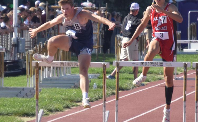 Left: Cole Redden clears his last hurdle in the 300m where he placed seventh. PCN photo by Kirk Sparrow.