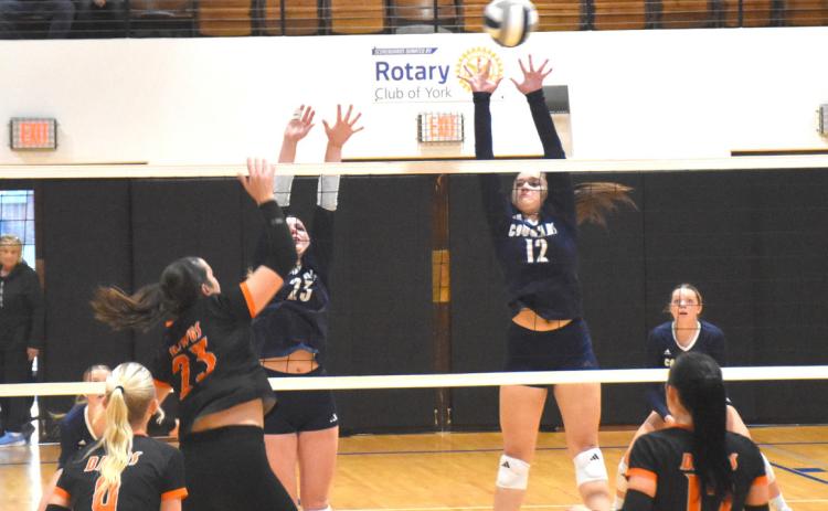 Top- Cross County junior Cortina Donnelly (12) sets for the block against the Osceola attack. Below-Senior Emersyn Prososki gets her hand on the ball against the Cross County kill attempt. PCN photos by Beth Sparrow