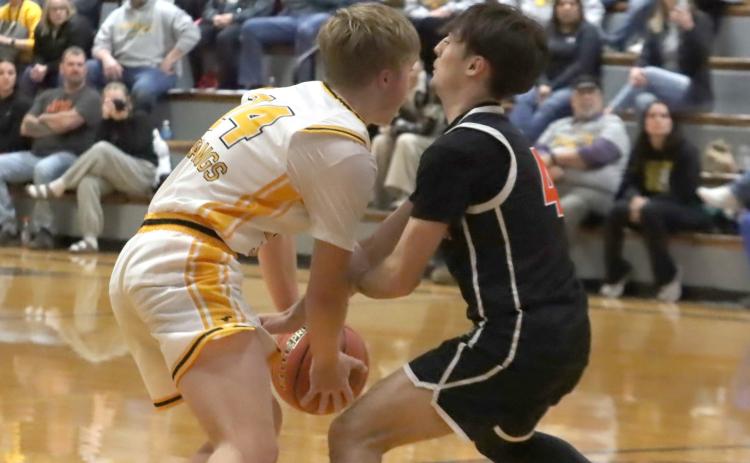 TOP-Osceola ‘s Brayden Santos (4) tries to steal the ball away from McCool Junction senior Carson McDonald (23) in first half action on Thursday at MCJ High School. PCN photos by Ken Kush.