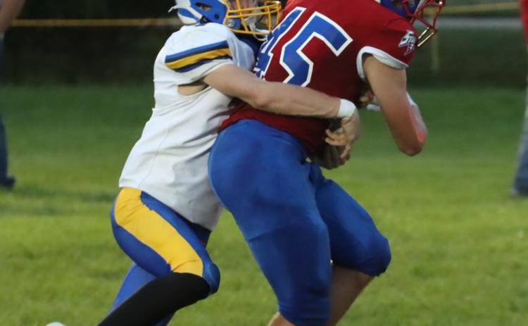 Top left- High Plains junior Chase Owens (45) refuses to be denied as he carries the Nebraska Lutheran defender into the end zone on this first quarter 11-yard scoring run. Owens also had a pick-six in the first quarter.