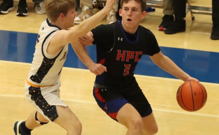 High Plains’ Carson Swedenburg looks for an open player in Monday’s game at York University. Swedenburg had 14 points in the Storms win over Nebraska Luth. PCN photo by Ken Kush.