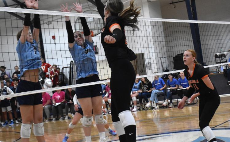 Bella Recker goes for the kill against Nebraska Christian blockers. PCN photo by Beth Sparrow.