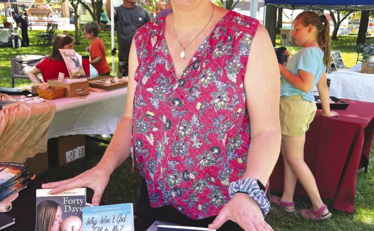 Above: Author Jenni DeWitt is pictured with her books at the Swedish Festival this last June. Photo provided.