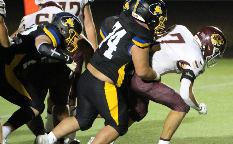 Led by 5-10, 260-pound junior Logan Pospisil (74) the Shelbyduring Friday nights game in Shelby. PCN photo by Travis Lane. RC defensive line hauls down the East Butler ball carrier