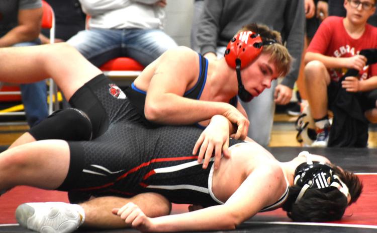 Wyatt Urkoski goes to state for the third year in a row as one of a few undefeated wrestlers. He pins his opponent at districts here. PCN photo by Beth Sparrow.