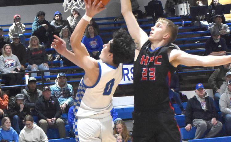 High Plains senior Brodey Spurling (23) attempts to block the shot of Twin River’s Corbin Rodriguez in Thursday’s game at Genoa. Spurling led the Storm in scoring with 20, but High Plains dropped the 63-48 final in CRC regular season hoops action. PCN photo by Beth Sparrow.