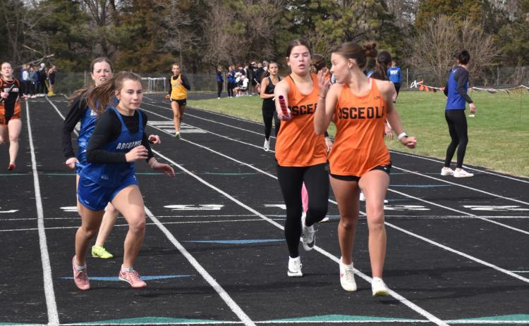 Osceola: Addison Theis hands off to Charisa Boden in the 4x400m relay. PCN photo by Beth Sparrow.